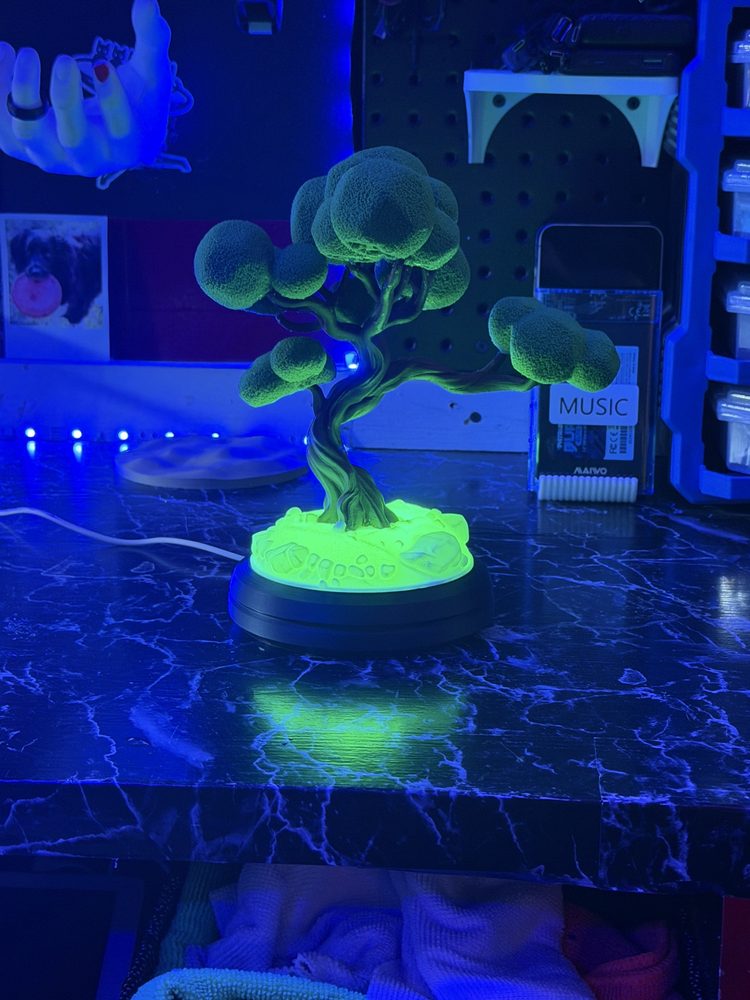 Bonsai tree lamp glowing green in the dark