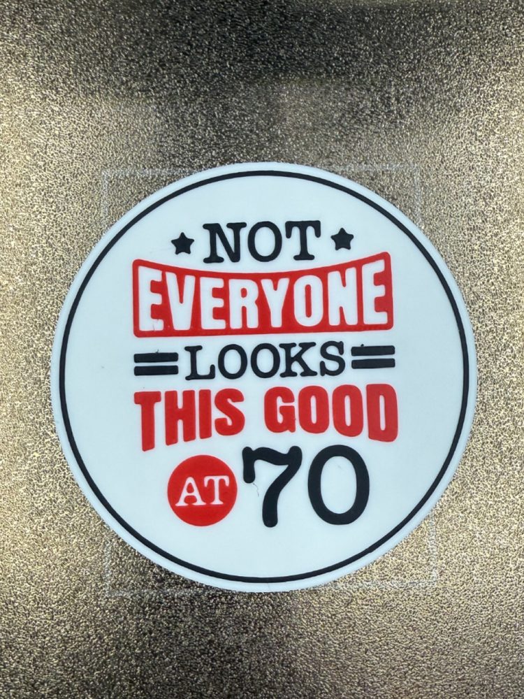 Round 3D-printed sign reading not everyone looks this good at 70