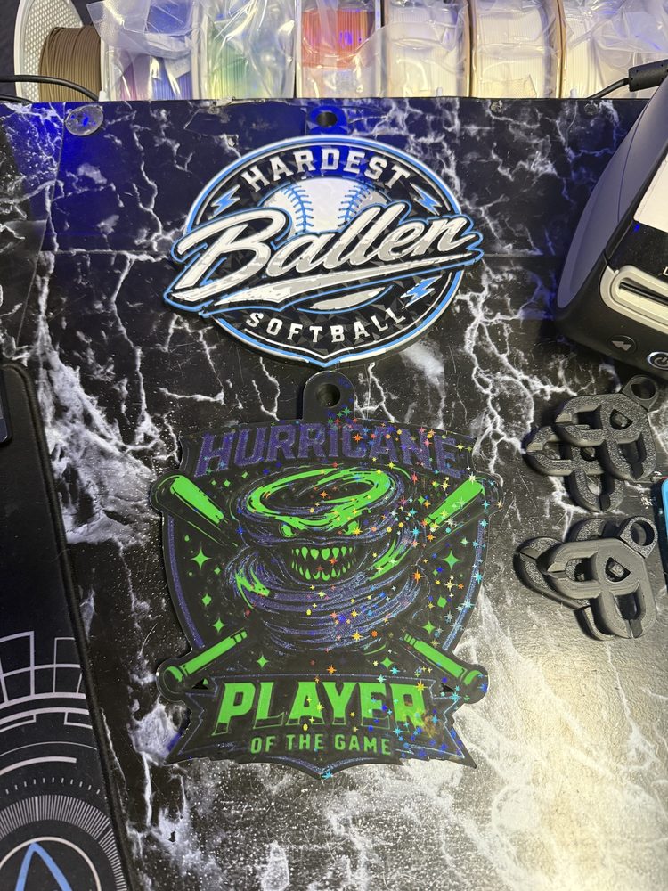 3D-printed softball medals reading Hardest Baller and Hurricane Player of the Game